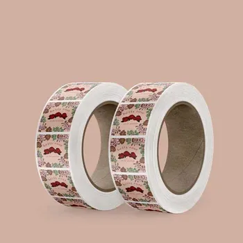 2 Rolls of standing square paper labels. The labels are for a perfume and contain rose and other floral illustrations