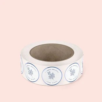 1 roll of circle synthetic silver labels. Labels are white with blue metallic details