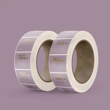 2 Rolls of square synthetic silver labels, labels are purple with metallic gold text. 